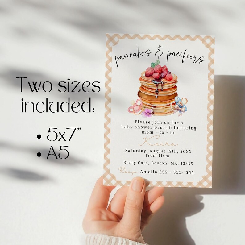 May include: Baby shower brunch invitation with the text "pancakes & pacifiers." The invitation includes a stack of pancakes topped with berries and syrup, and two pacifiers. The invitation is available in 5x7 inch and A5 sizes.
