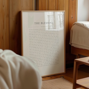 May include: A white framed print with the text "THE BLESSING" and a passage from Deuteronomy 28:1-14. The text is in a black font on a white background.