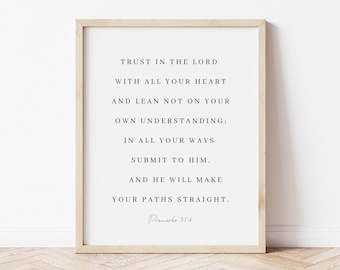 May include: A framed print with a white background and black text. The text reads "Trust in the Lord with all your heart and lean not on your own understanding; In all your ways submit to Him, and He will make your paths straight." The text is followed by "Proverbs 3:5-6".