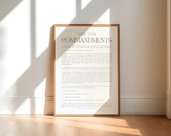 May include: A framed print with a white background and black text. The text reads "The Ten Commandments" and lists the ten commandments in a simple, modern font.