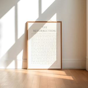 May include: A black and white print with a wooden frame. The print features the text "The Resurrection" and a passage from the Bible, Matthew 28:1-10.