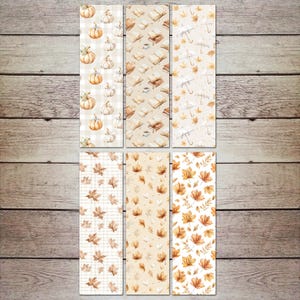 Può includere: Set di sei segnalibri rettangolari con motivi autunnali. I disegni includono zucche, libri, ombrelli e foglie autunnali nei toni dell'arancione, beige e marrone. I segnalibri sono disposti su una superficie di legno.