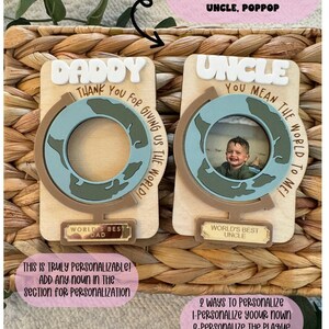 May include: Two wooden photo frames, one labeled "DADDY" and the other "UNCLE". Each frame features a globe design with a space for a photo. The "DADDY" frame says "Thank you for giving us the world!" and the "UNCLE" frame says "You mean the world to me!"