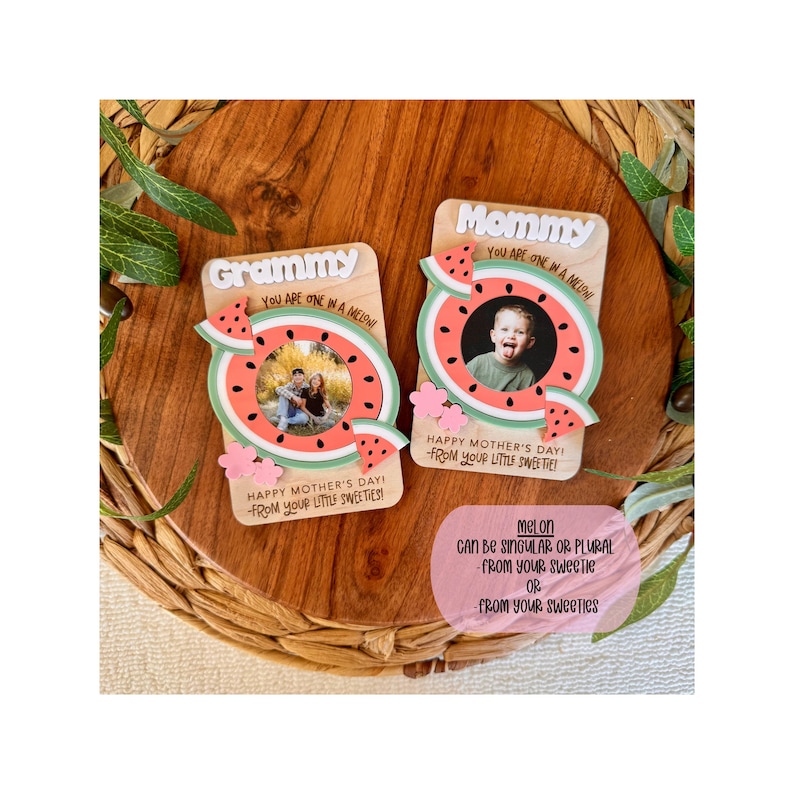 May include: Two wooden Mother's Day gifts with watermelon designs. One says "Grammy" and the other says "Mommy." Each has a photo inside a watermelon slice, with text "Happy Mother's Day! From your little sweetie!"