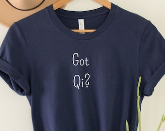 May include: A navy blue t-shirt with the text "Got Qi?" in white lettering.