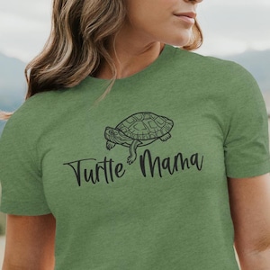 May include: Green t-shirt with a black outline of a turtle and the text "Turtle Mama" in black.