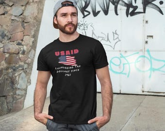USAID Because Money Doesn't Launder Itself Tee - Unisex Graphic Political Shirt, Statement Tee, Gift for Activist & Patriotic Apparel