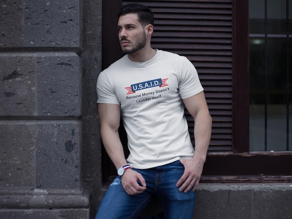 USAID Because Money Doesn't Launder Itself Tee - Unisex Graphic Political Shirt, Statement Tee, Gift for Activist & Patriotic Apparel