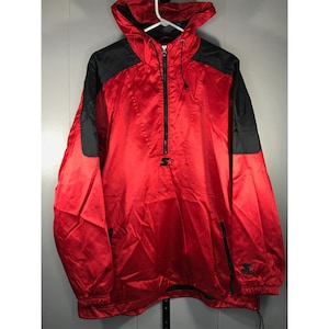 May include: Red and black Starter brand anorak jacket with a hood and a half-zip closure. The jacket features a black logo on the chest and black panels on the shoulders. It has two front pockets and a drawstring at the bottom.