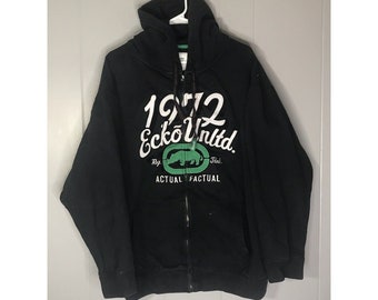 May include: Black zip-up hoodie with a green and white logo that says "1972 Ecko Unltd. Reg. TM. Actual Factual".