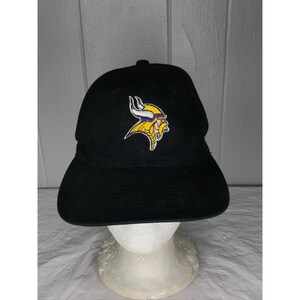 May include: Black baseball cap with a purple and yellow Minnesota Vikings logo embroidered on the front.