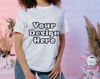 Fashion Forward T-Shirt Mockup on Model with Pastel Pink Background - Ideal for Displaying Your Custom Apparel Designs