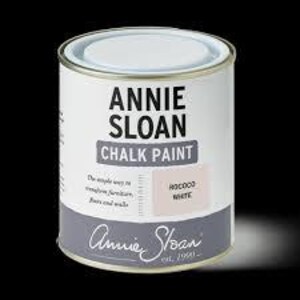 May include: A cylindrical can of Annie Sloan Chalk Paint in 'Old White'. The can is white with a gray band at the bottom and a label indicating the paint color. The text 'Annie Sloan' and 'Chalk Paint' are prominently displayed.