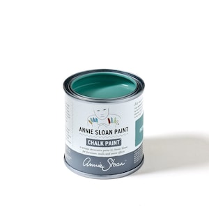 May include: A round metal can of Annie Sloan Chalk Paint in the color Provence. The paint is a light teal blue color. The can has a white label with the Annie Sloan logo and the text "Annie Sloan Chalk Paint" and "a unique decorative paint by Annie Sloan for furniture, walls and paint effects".