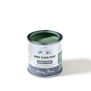 May include: A can of Annie Sloan Chalk Paint in Duck Egg Blue. The paint can is open, revealing the light green paint inside. The label features the brand name, a drawing of a person, and the words "CHALK PAINT".