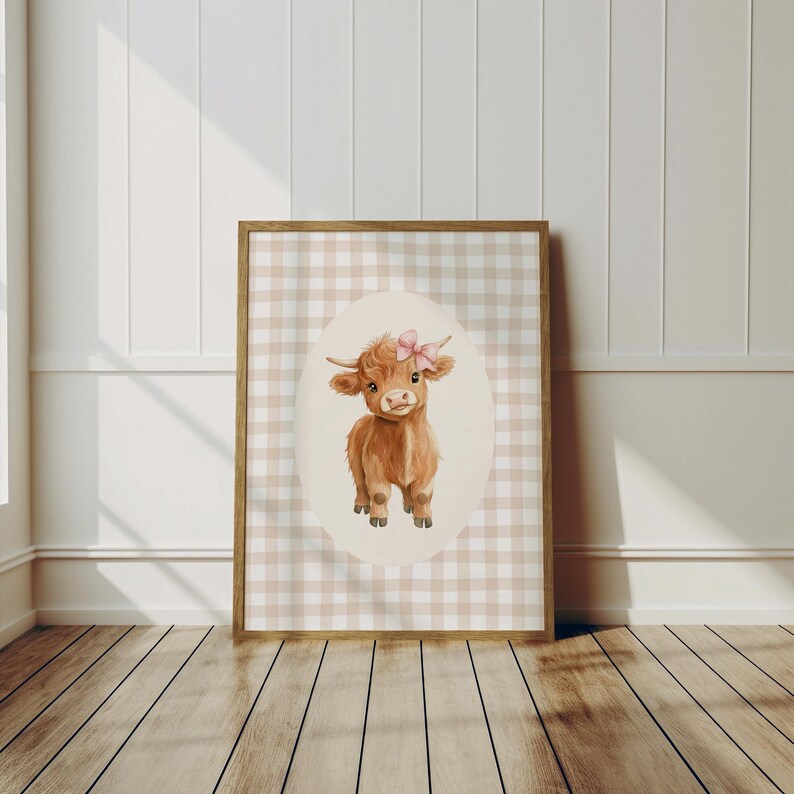 May include: A watercolor illustration of a brown Highland cow with a pink bow on its head. The cow is standing on a white background with a brown and white gingham pattern.