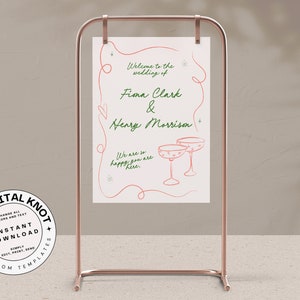 Pu&ograve; includere: Un cartello da matrimonio stampabile con un design rosa e bianco. Il cartello dice "Benvenuti al matrimonio di Fiona Clark & Henry Morrison. Siamo cos&igrave; felici che siate qui."