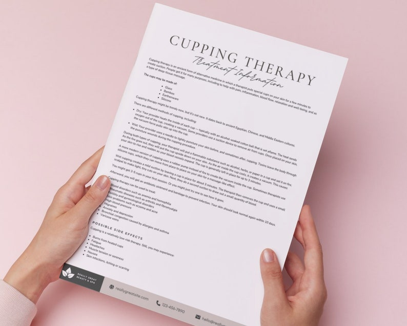 May include: A close-up of a white sheet of paper with the title "Cupping Therapy Treatment Information" printed in black. The text describes the history and benefits of cupping therapy, a form of alternative medicine. The paper is held by a person's hands.