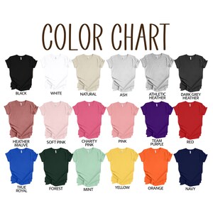 May include: Color chart showing 18 different t-shirt colors. The colors include black, white, natural, ash, heather mauve, soft pink, charity pink, pink, team purple, red, true royal, forest, mint, yellow, orange, and navy.