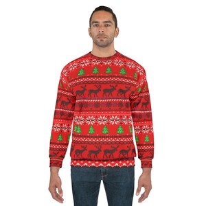 May include: A red Christmas jumper with a festive pattern of reindeer, snowflakes, and green Christmas trees. The jumper has a crew neck and long sleeves. The design is repeated across the front and sleeves.