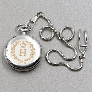A silver pocket watch with a letter engraved on the front cover. You can customize the pocket watch in the picture as you want. It also comes with a personalized wooden gift box. Silver color pocket watch