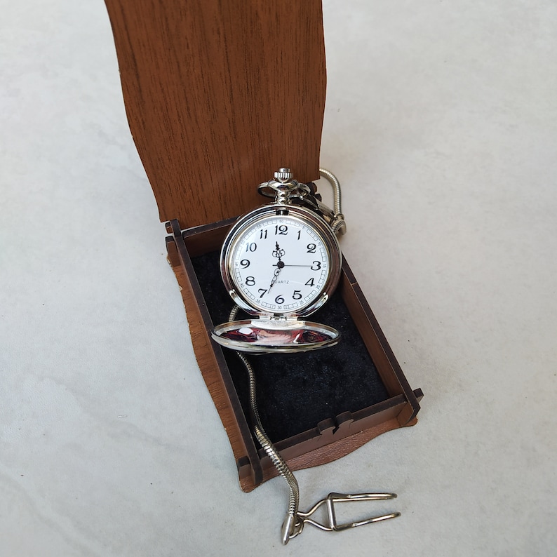 A pocket watch with a specially designed logo or image printed in a brown personalized wooden gift box. Silver color pocket watch. Personalized gift pocket watch and gift box