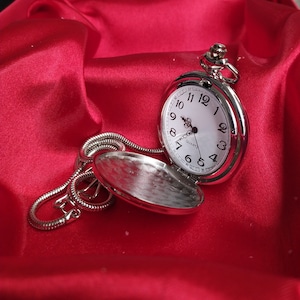 A cute and stylish looking silver pocket watch that you can give to your husband as an anniversary gift