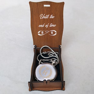 The infinity symbol engraved on the wooden gift box and a silver personalized pocket watch. Groomsmen gift silver color pocket watch in customized wooden gift box