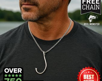May include: A silver fishing hook necklace with a chain. The necklace is worn by a person. The image includes the text "Includes Free Chain" and "Reel Monster".