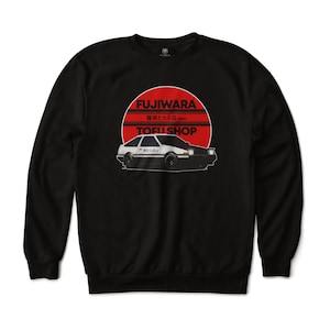 May include: Black sweatshirt with a white car and a red sun graphic. The graphic says "Fujiwara Tofu Shop" in Japanese and English.