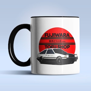 May include: White ceramic mug with a black handle. The mug features a red and white illustration of a car with the text "FUJIWARA", "豆腐屋", and "TOFU SHOP" in black.