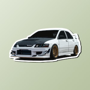 May include: A white Mitsubishi Lancer Evolution with a black hood, gold wheels, and a black and white bumper.