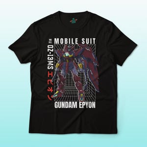 May include: Black t-shirt featuring a graphic of a Gundam Epyon mobile suit. The design includes the text "MOBILE SUIT" and "GUNDAM EPYON" in white, along with Japanese text and a grid background. The shirt is a crew neck.