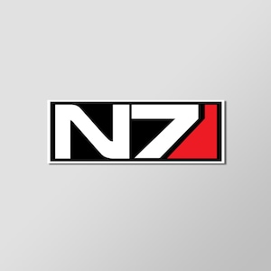 May include: A rectangular sticker featuring the stylized letters "N7" in white against a black background. The right side of the design has a red triangle. The sticker has a white border.