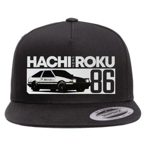 May include: Black and white flat brimmed baseball cap with a white graphic of a car and the text "HACHIROKU 86" and Japanese characters. The cap has a black adjustable strap with a silver snap closure and a silver sticker on the back that says "The Classics Snapback Yurong Since 1991."