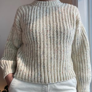 A white knit ribbed fisherman style crochet sweater pattern. Easy for beginners and looks knit