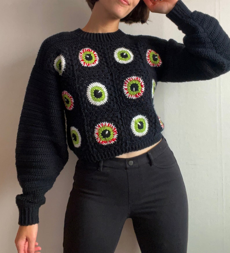 Size inclusive spooky Halloween crochet granny square eyeball sweater. Comes cropped with a relaxed fit and cozy bishop sleeves. Video tutorials for granny square eyeballs.