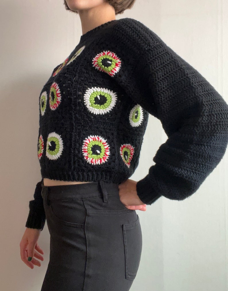 Size inclusive spooky Halloween crochet granny square eyeball sweater. Comes cropped with a relaxed fit and cozy bishop sleeves. Video tutorials for granny square eyeballs.