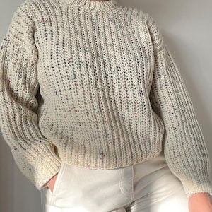 A white knit ribbed fisherman style crochet sweater pattern. Easy for beginners and looks knit