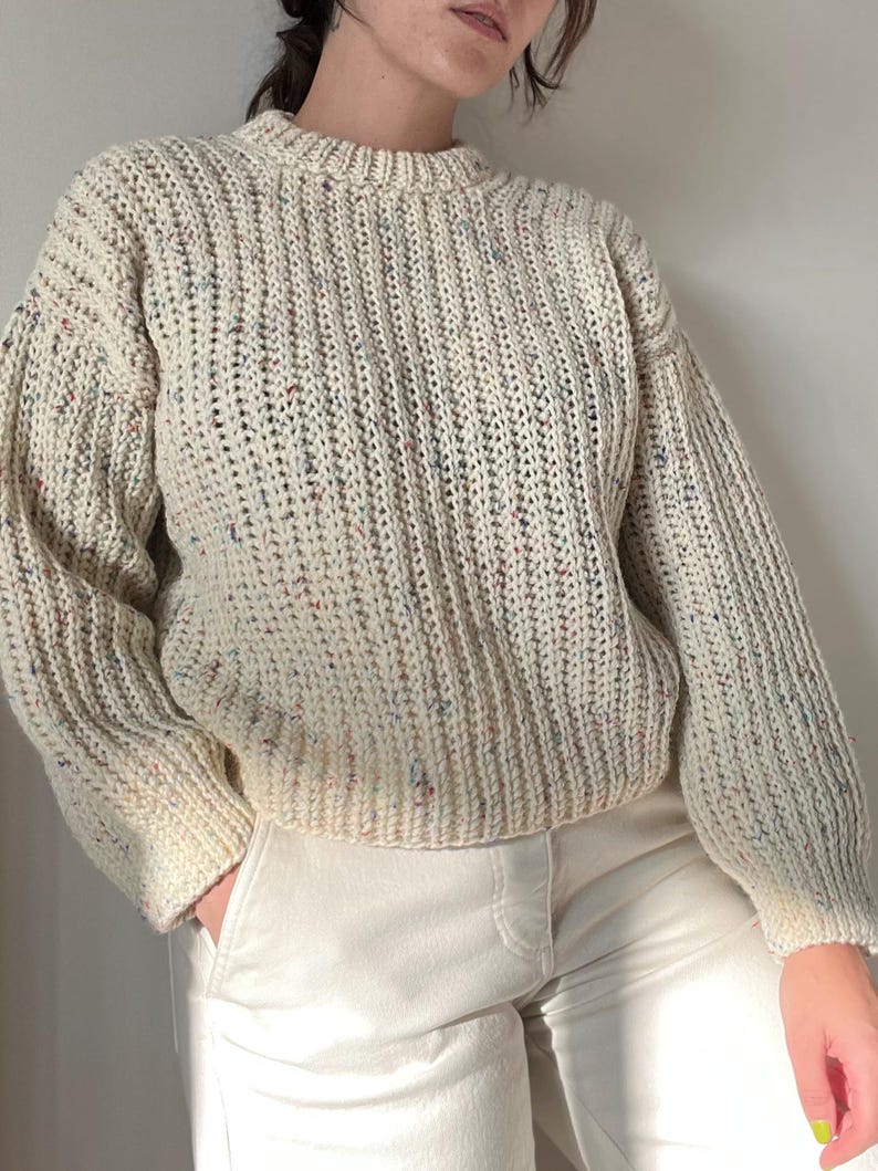 A white knit ribbed fisherman style crochet sweater pattern. Easy for beginners and looks knit