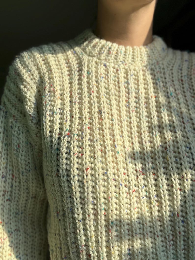 A white knit ribbed fisherman style crochet sweater pattern. Easy for beginners and looks knit