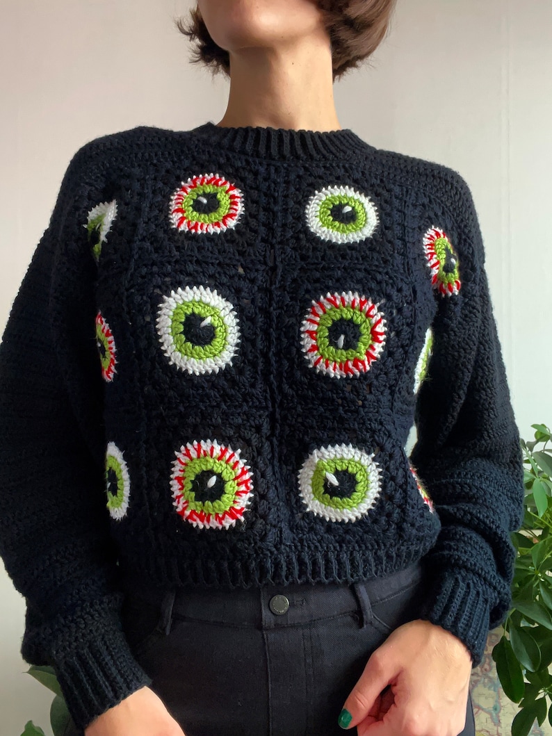 Size inclusive spooky Halloween crochet granny square eyeball sweater. Comes cropped with a relaxed fit and cozy bishop sleeves. Video tutorials for granny square eyeballs.