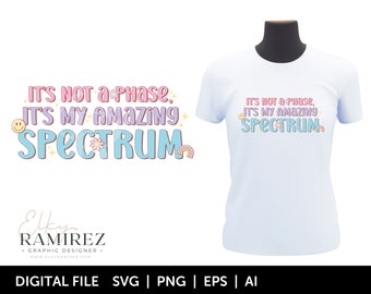 May include: A digital design file for a t-shirt featuring the text "It's not a phase, it's my amazing spectrum" in a colorful, playful font with rainbow and flower accents.