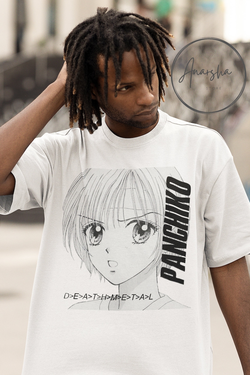 May include: White t-shirt with a black and white anime-style illustration of a girl with large eyes. The text "PANCHIKO" is printed vertically on the right side of the shirt. The text "D>E>A>T>H>M>E>T>A>L" is printed below the illustration.