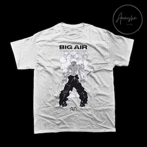 May include: A white t-shirt with a black and white graphic print of a person with the text "BIG AIR" above the graphic. The text below the graphic says "Don't think people can't see you. It's not when you make big air, it's how you land.  Perfectly.  Consistently.  Make it count.  You're not just a rider, you're a legend."