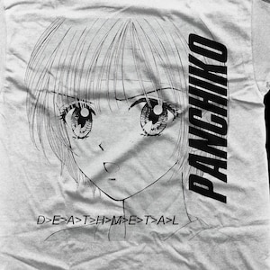 May include: Black and white illustration of a girl with large eyes and short hair. The text "PANCHIKO" is printed vertically on the right side of the image. The text "D>E>A>T>H>M>E>T>A>L" is printed below the girl's face.
