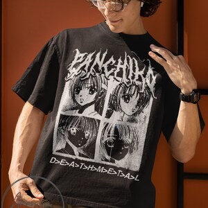 May include: A black t-shirt with a white graphic print of four anime-style faces in squares. The text "D>E>A>S>T>H>M>E>T>A>L" is printed below the faces.