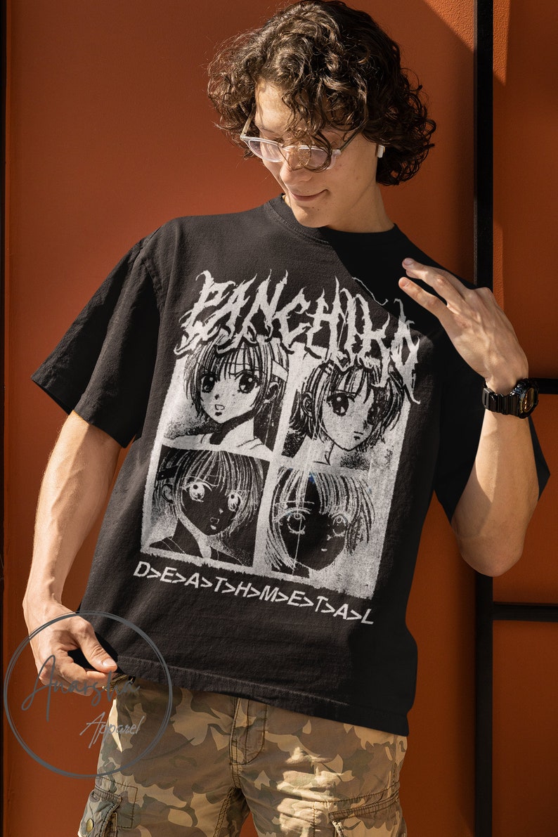 May include: A black t-shirt with a white graphic print of four anime-style faces in squares. The text "D>E>A>S>T>H>M>E>T>A>L" is printed below the faces.