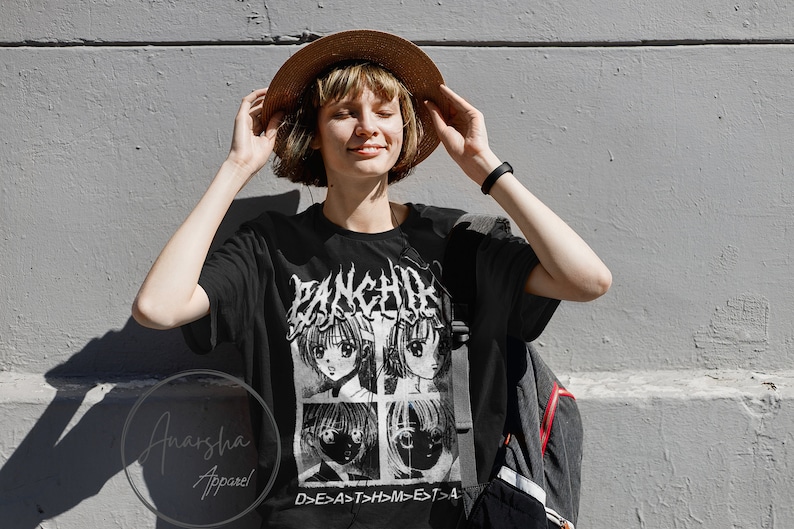 May include: A black t-shirt with a white graphic print of four anime characters. The graphic includes the text "PANCHIRA" and "D>E>A>T>H>M>E>T>A".