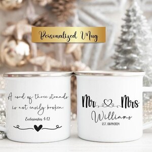 May include: Two white enamel mugs with silver rims. The left mug features the black text A cord of three strands is not easily broken, Ecclesiastes 4:12, and a heart icon. The right mug displays Mr. & Mrs. Williams, a heart, and EST. 08/19/2024.